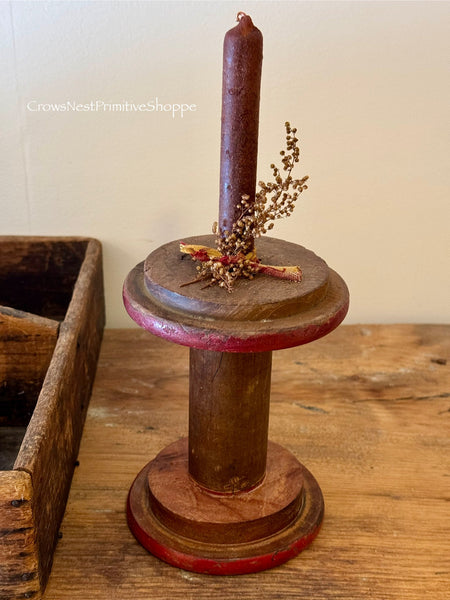 Antique wooden bobbin with spiced candle