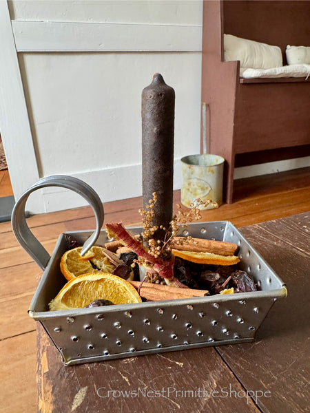 Metal grater candle holder with Rosehips and sliced oranges