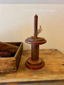 Antique wooden bobbin with spiced candle