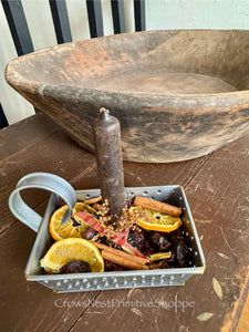 Metal grater candle holder with Rosehips and sliced oranges